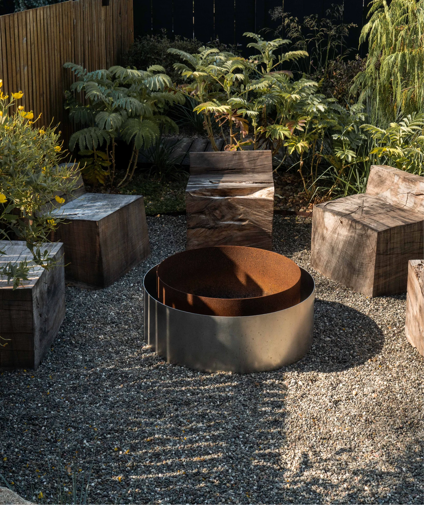 ORCA Concentric Fire Pit in copper finish on stone patio