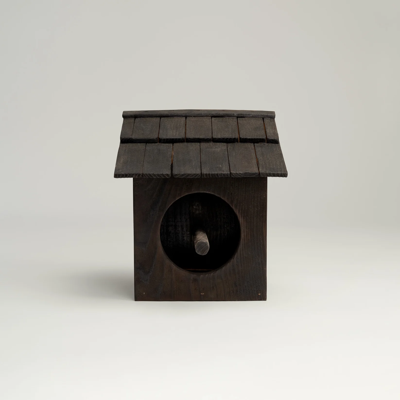ORCA charred cedar birdhouse mounted on a garden post